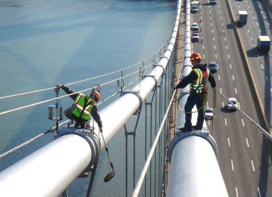 Civil inspectors on top of bridge inspecting for damages with AIR Corp's advanced software technology.